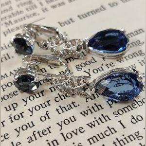 Vintage sapphire rhinestone Panetta clip earrings with rhodium silver plate.